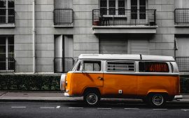 white and orange Volkswagen Kombi on road